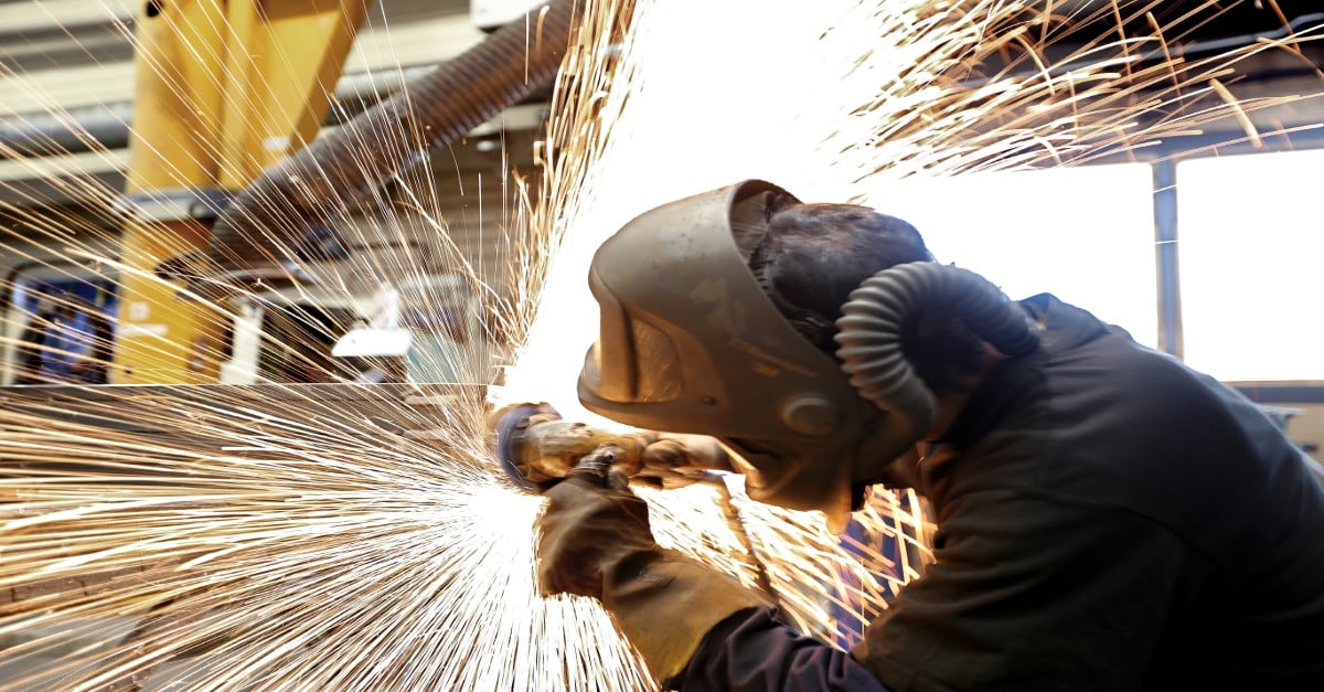 a worker grinding metal